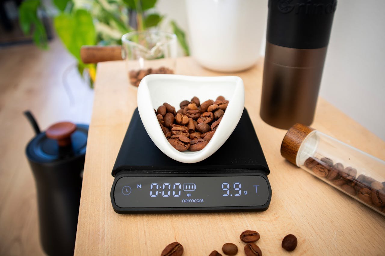 A digital scale with coffee beans, ideal for precise coffee brewing in a cozy home setting.
